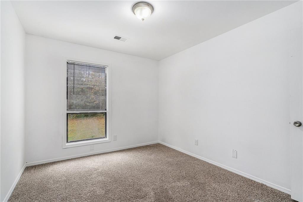 5444 Wylstream Way Norcross, GA 30093 - Photo 7 of 12 an empty room with windows