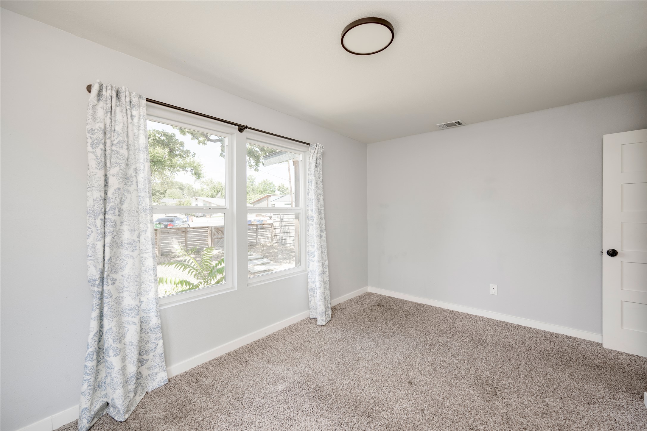 1400 Marcus Place, Unit B Austin, TX 78721 - Photo 14 of 39 Two well-placed windows allow plentiful natural light to fill this cozy bedroom space.