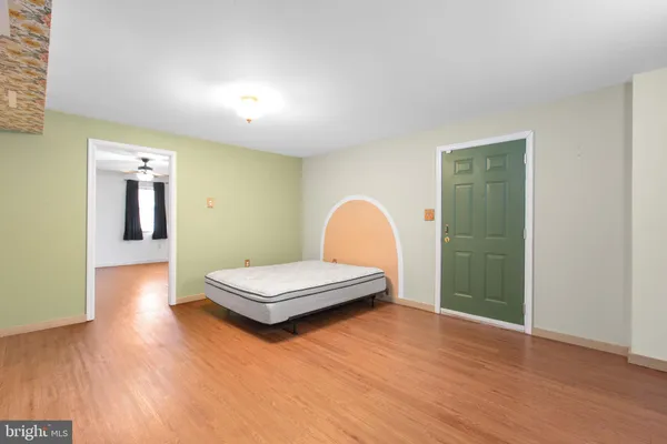 a living room with hard wood floors and a wooden floors