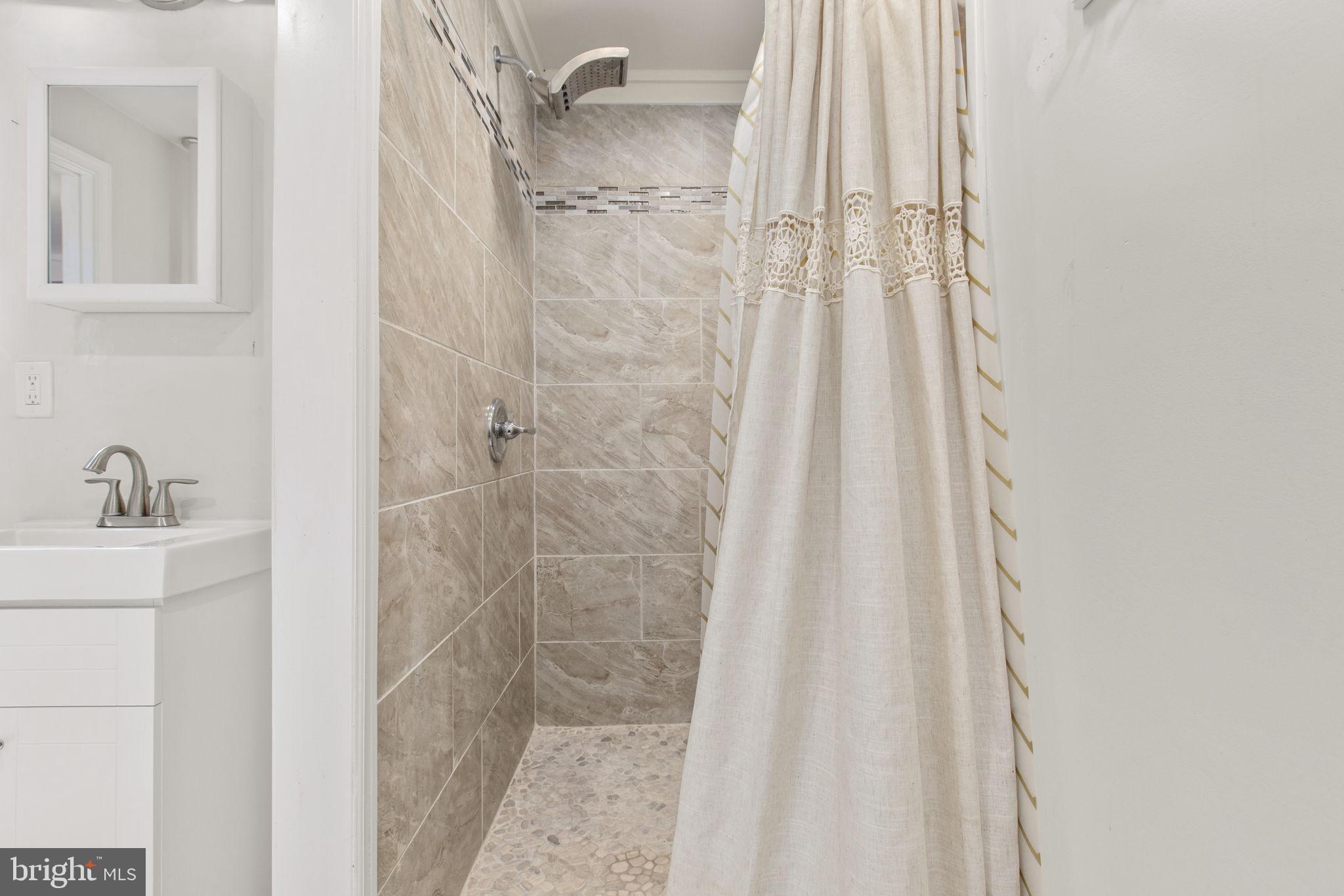 7312 Sugar Hollow Road Orange, VA 22960 - Photo 17 of 47 a bathroom with a shower curtain and a sink