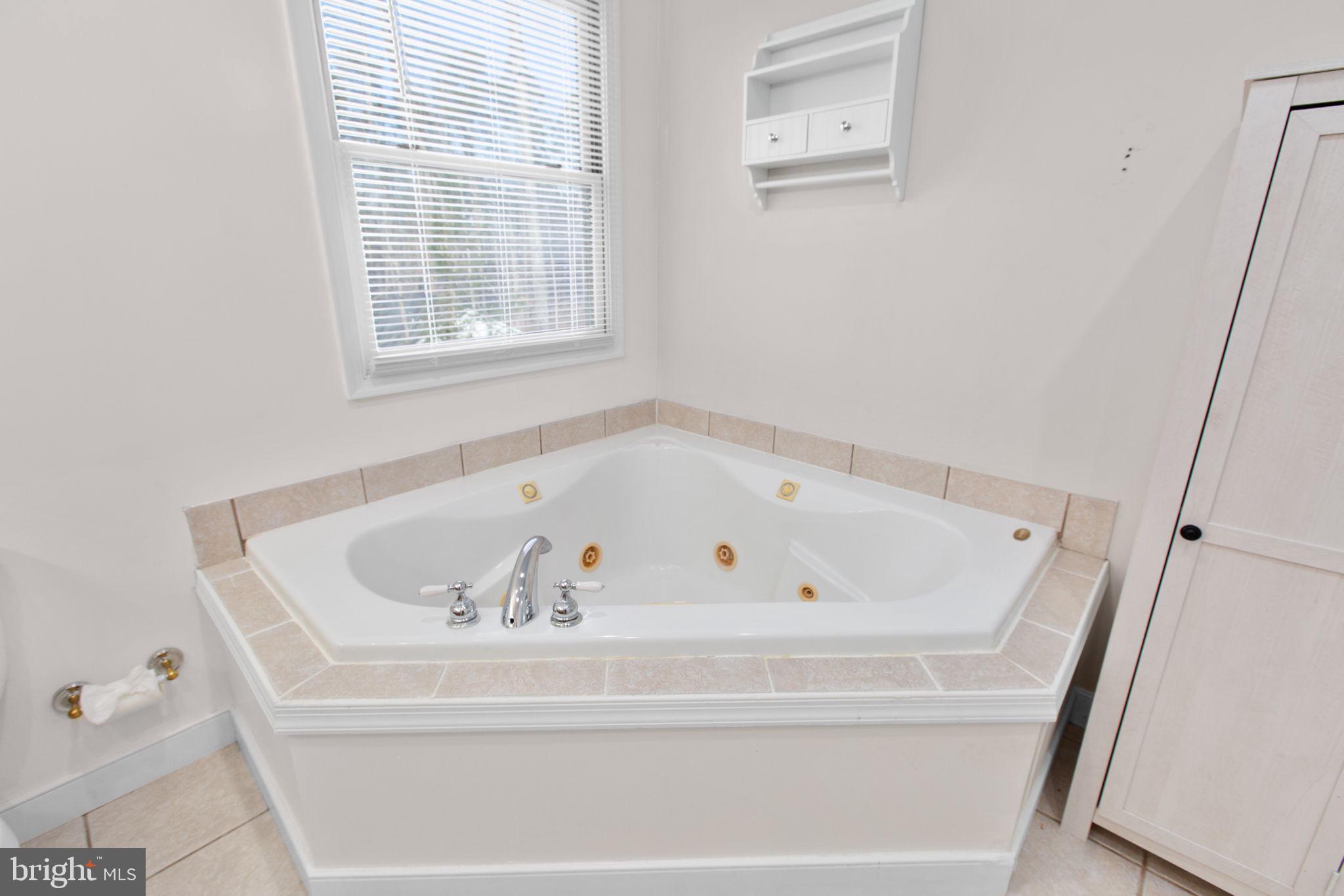 7312 Sugar Hollow Road Orange, VA 22960 - Photo 28 of 47 a white bath tub sitting in a bathroom