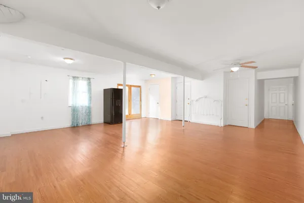 a view of an empty room with wooden floor