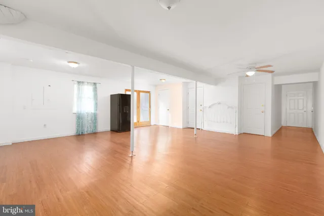 a view of an empty room with wooden floor