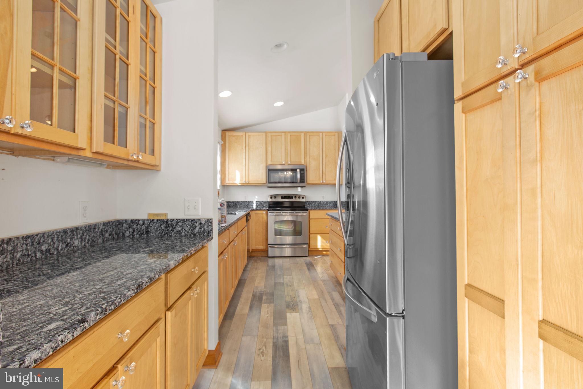 7312 Sugar Hollow Road Orange, VA 22960 - Photo 3 of 47 a view of a kitchen with kitchen island a counter top space a sink a refrigerator and a window