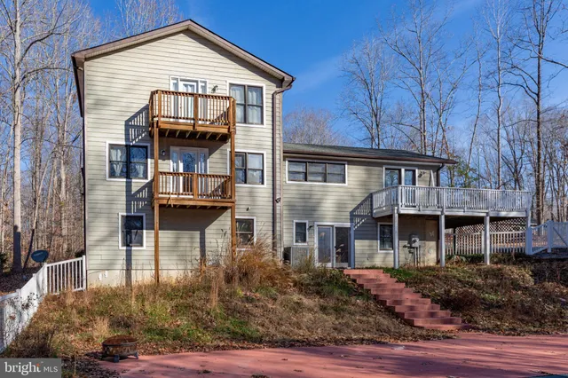 a backyard of a house with yard and outdoor seating
