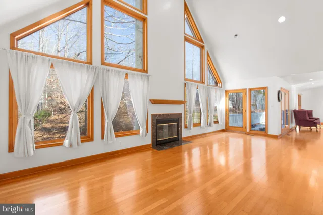 a view of an entryway with floor to ceiling windows and a fireplace