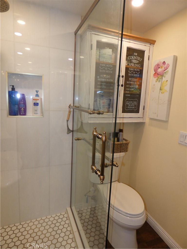 334 West Santa Elena Road Palm Springs, CA 92262 - Photo 12 of 45 a bathroom with a toilet and a shower
