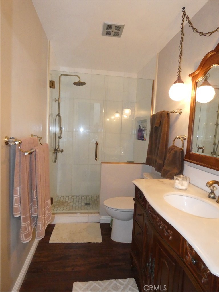334 West Santa Elena Road Palm Springs, CA 92262 - Photo 20 of 45 a bathroom with a double vanity sink a toilet a mirror and shower
