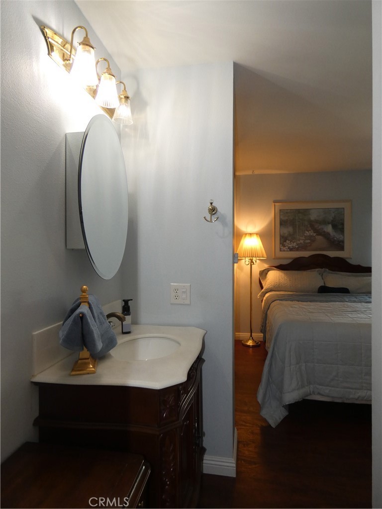 334 West Santa Elena Road Palm Springs, CA 92262 - Photo 21 of 45 a en suite bathroom with a sink and a mirror