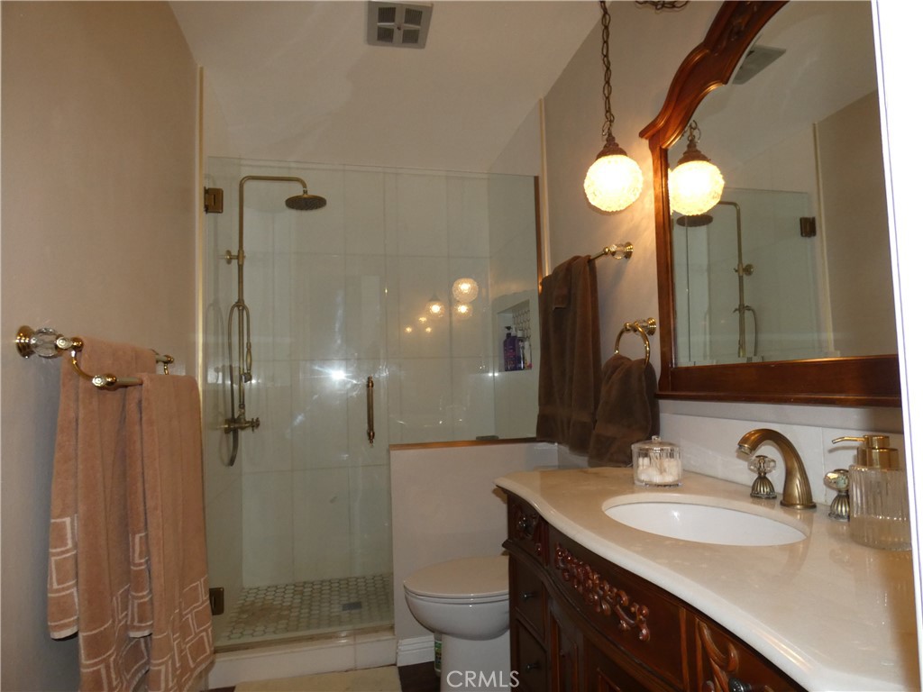 334 West Santa Elena Road Palm Springs, CA 92262 - Photo 22 of 45 a bathroom with a sink vanity toilet and shower