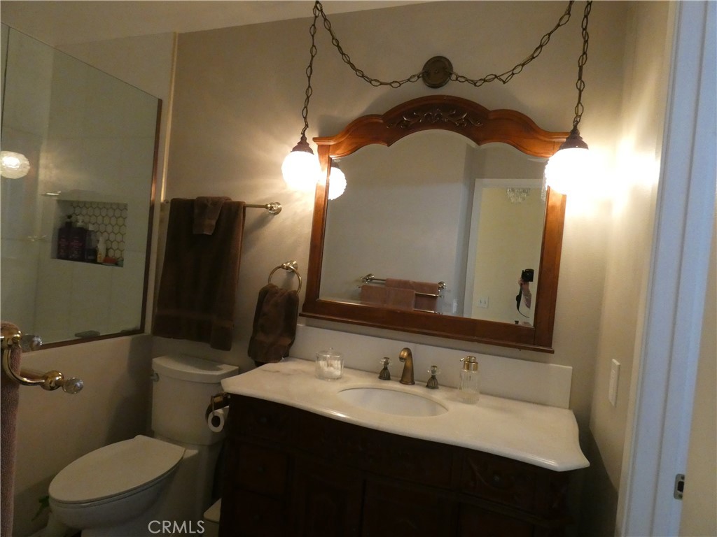 334 West Santa Elena Road Palm Springs, CA 92262 - Photo 23 of 45 a bathroom with a toilet sink and mirror