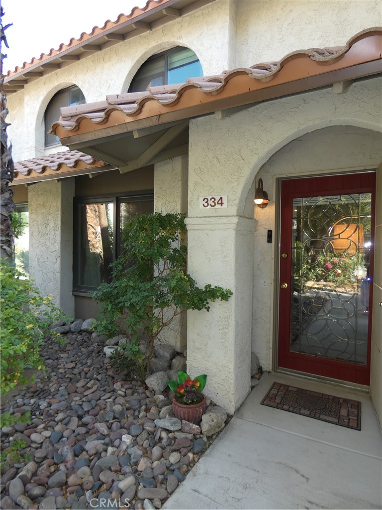 334 West Santa Elena Road Palm Springs, CA 92262 - Photo 3 of 45 a front view of a house with garden
