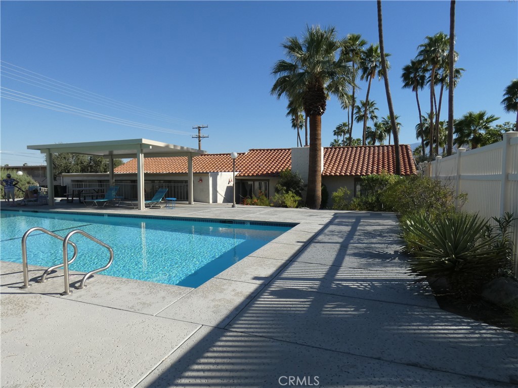 334 West Santa Elena Road Palm Springs, CA 92262 - Photo 37 of 45 a swimming pool with outdoor seating and yard