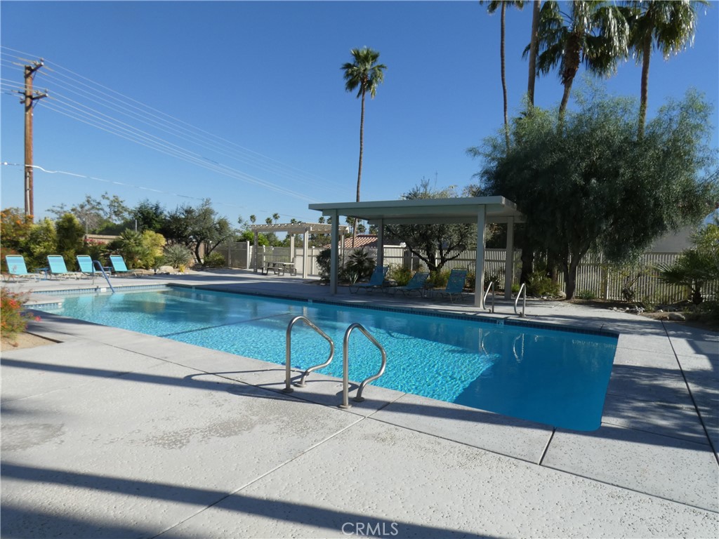 334 West Santa Elena Road Palm Springs, CA 92262 - Photo 43 of 45 a view of swimming pool with a bench