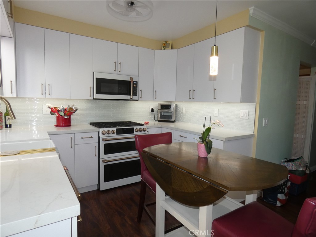 334 West Santa Elena Road Palm Springs, CA 92262 - Photo 7 of 45 a kitchen with a stove a sink and a refrigerator