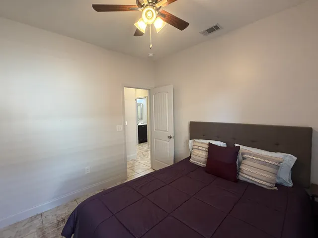 a bathroom with a sink a toilet a mirror and shower