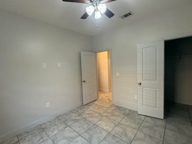 a backyard of a house with barbeque oven table and chairs
