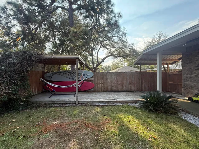 a view of a house with swimming pool and a yard