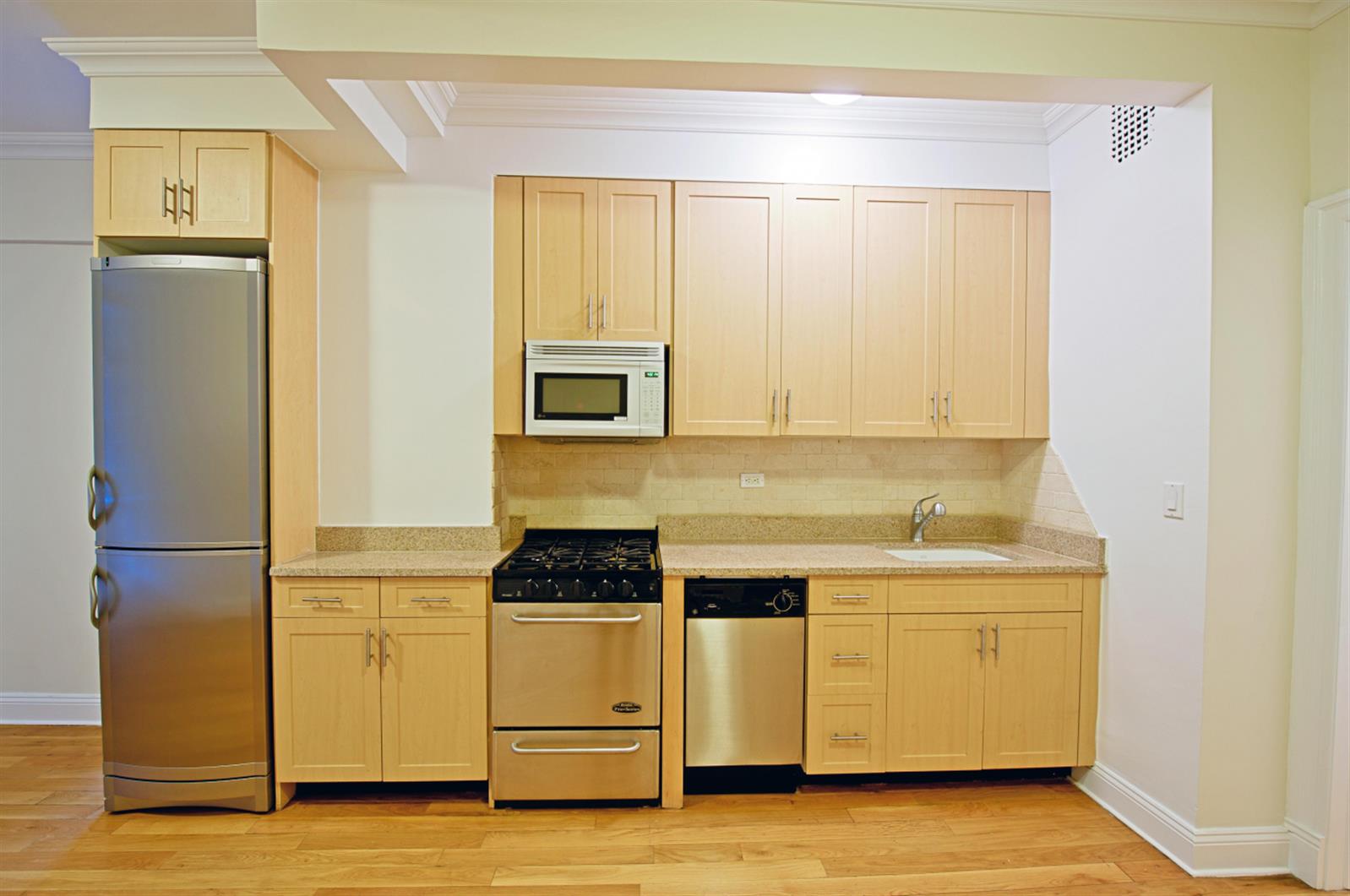 a kitchen with a refrigerator a stove a microwave and cabinets