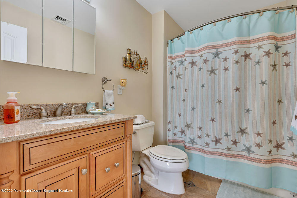 111 Parker Road Tuckerton, NJ 08087 - Photo 54 of 75 a bathroom with a sink a toilet and shower curtain