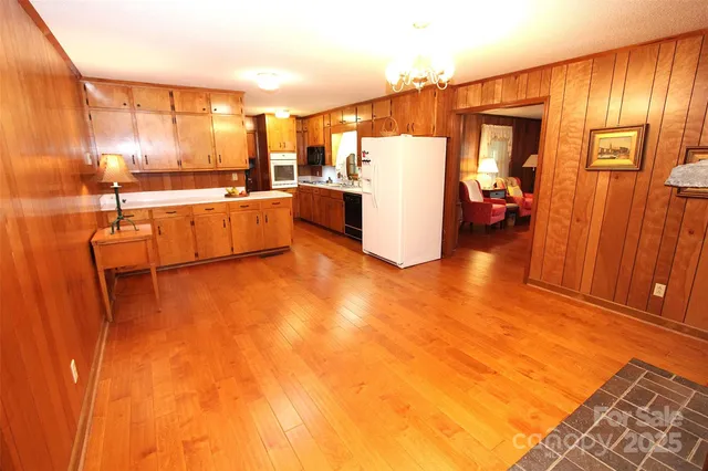 a kitchen with stainless steel appliances a refrigerator and wooden cabinets