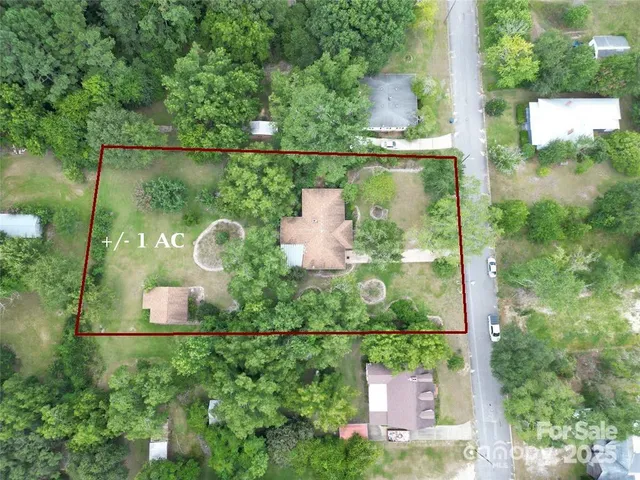 an aerial view of a garden space with a table & chairs