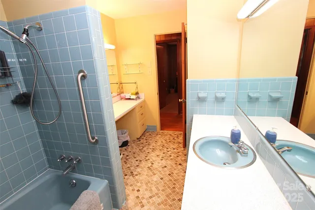 a bathroom with a tub and shower