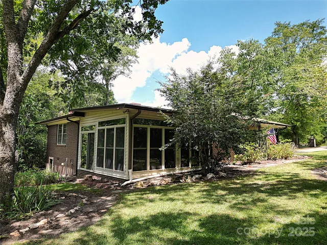 a view of a house with a yard and sitting area
