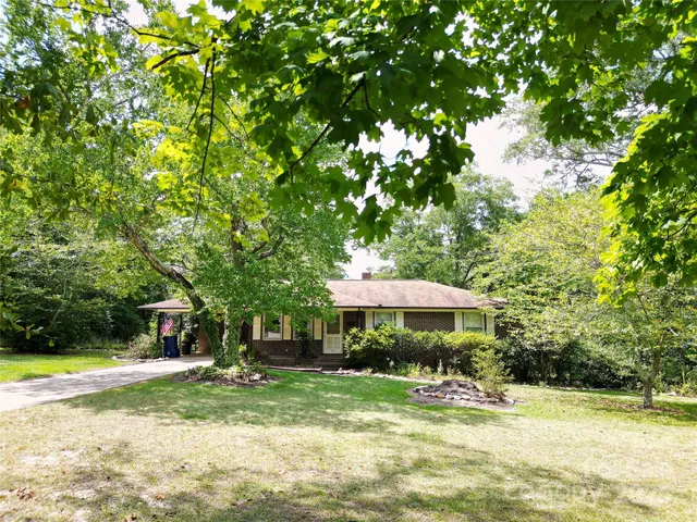 a backyard of a house with yard and outdoor seating