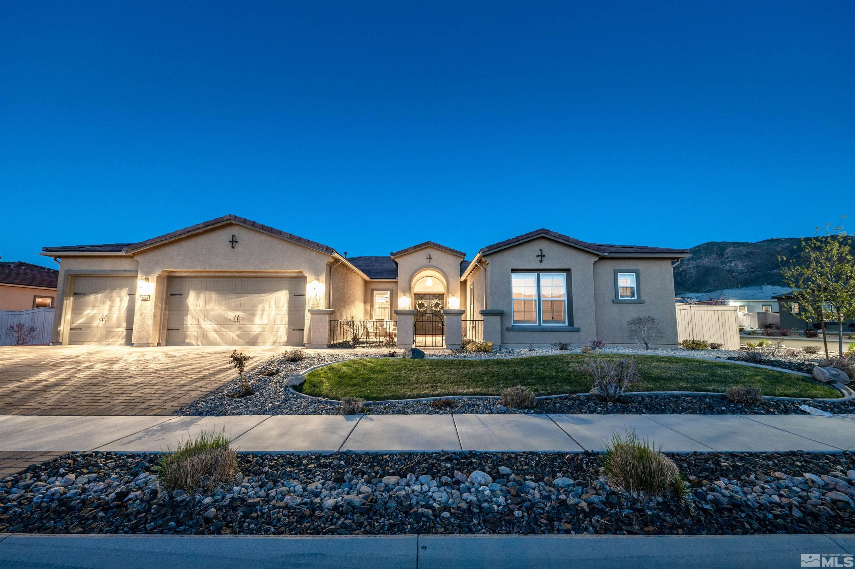 a front view of a house with a yard and garage