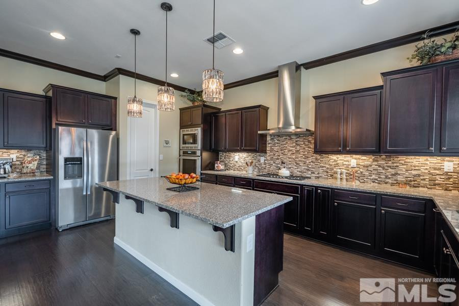 9898 Firefoot Lane Reno, NV 89521 - Photo 11 of 40 a kitchen with stainless steel appliances granite countertop a sink stove and refrigerator