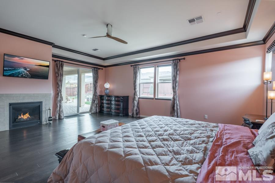 9898 Firefoot Lane Reno, NV 89521 - Photo 14 of 40 a bedroom with a large bed and a fireplace