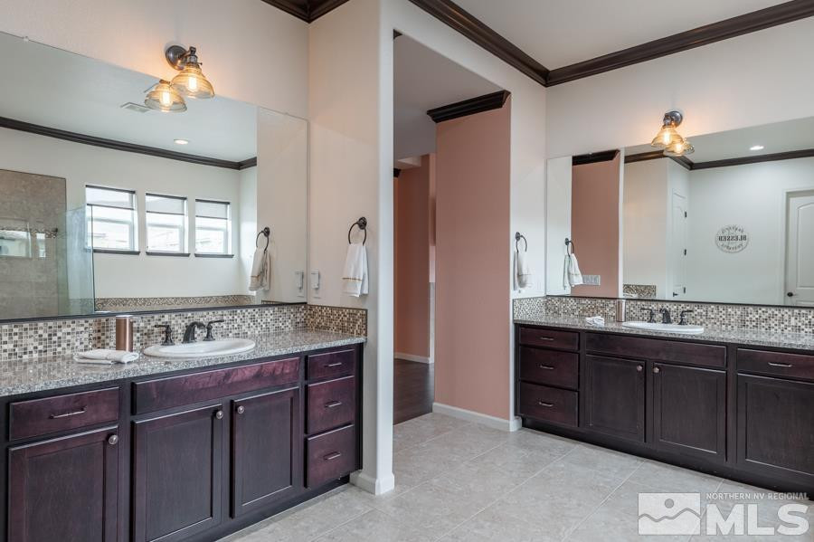 9898 Firefoot Lane Reno, NV 89521 - Photo 15 of 40 a bathroom with a granite countertop sink a large mirror and a shower