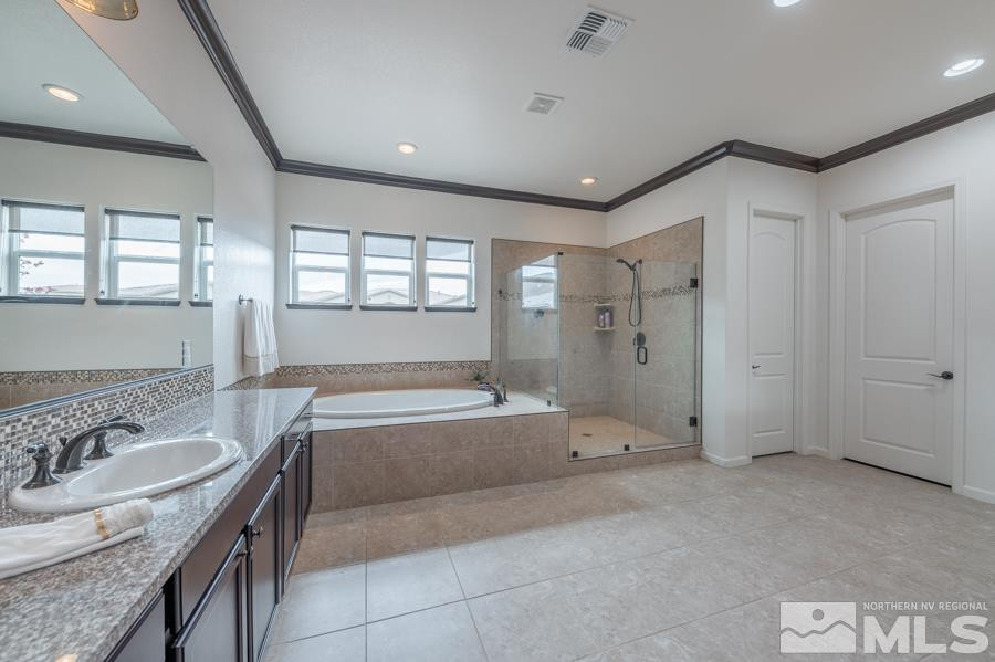 9898 Firefoot Lane Reno, NV 89521 - Photo 16 of 40 a spacious bathroom with a granite countertop tub sink shower and mirror