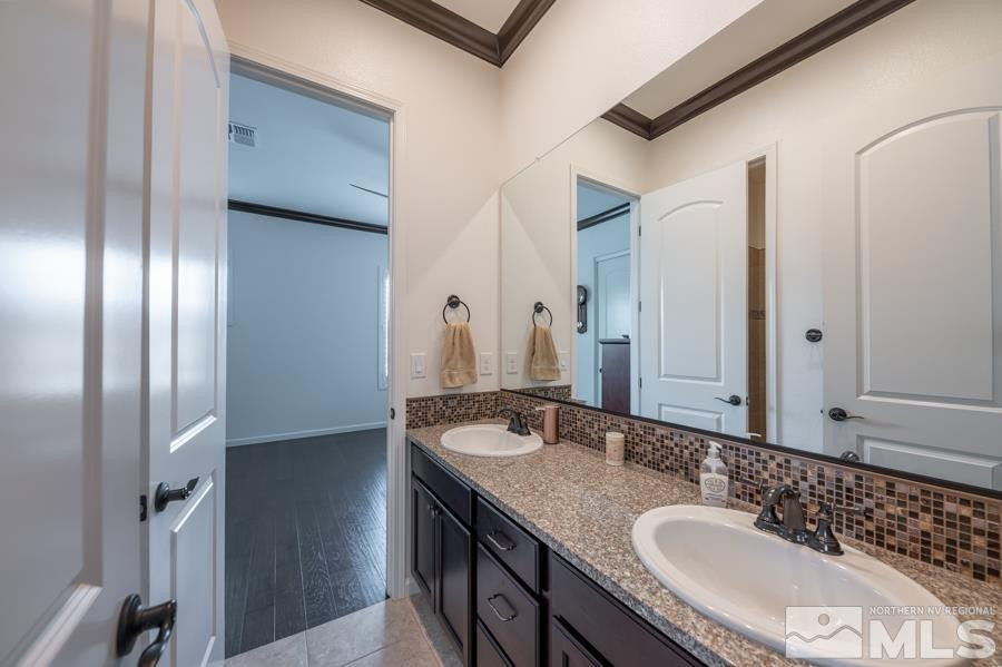 9898 Firefoot Lane Reno, NV 89521 - Photo 20 of 40 a bathroom with a granite countertop double vanity sink and a mirror