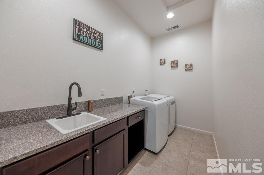 9898 Firefoot Lane Reno, NV 89521 - Photo 22 of 40 a bathroom with a granite countertop sink a mirror and vanity