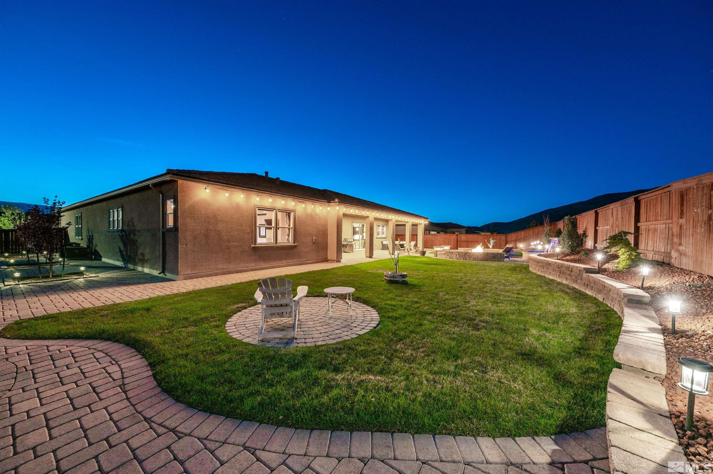 9898 Firefoot Lane Reno, NV 89521 - Photo 30 of 40 a backyard of a house with yard and outdoor seating