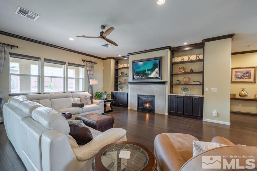 9898 Firefoot Lane Reno, NV 89521 - Photo 5 of 40 a living room with furniture a fireplace and a flat screen tv