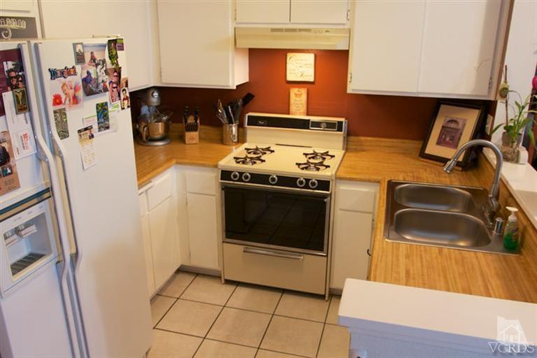 1742 Sinaloa Road, Unit 335 Simi Valley, CA 93065 - Photo 13 of 28 a kitchen with a stove and a refrigerator