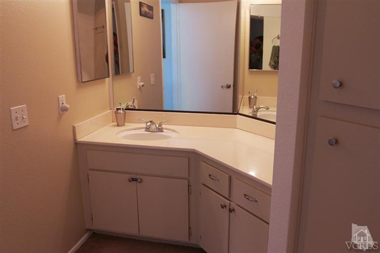 1742 Sinaloa Road, Unit 335 Simi Valley, CA 93065 - Photo 23 of 28 a bathroom with a sink and a mirror