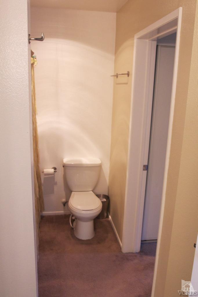 1742 Sinaloa Road, Unit 335 Simi Valley, CA 93065 - Photo 24 of 28 a white toilet sitting next to a shower