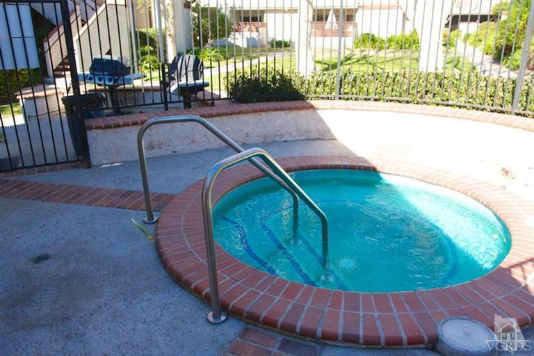 1742 Sinaloa Road, Unit 335 Simi Valley, CA 93065 - Photo 25 of 28 a view of a swimming pool with a chairs in a patio