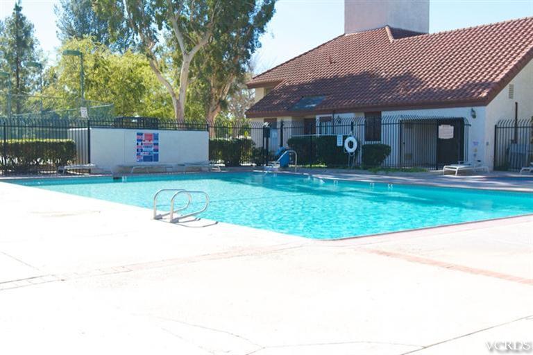 1742 Sinaloa Road, Unit 335 Simi Valley, CA 93065 - Photo 5 of 28 a front view of a house with a yard and garage