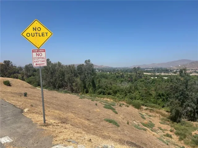 a view of a street with a building in the background
