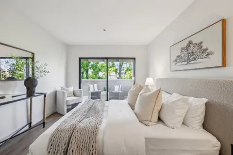 a bedroom with bed and a window