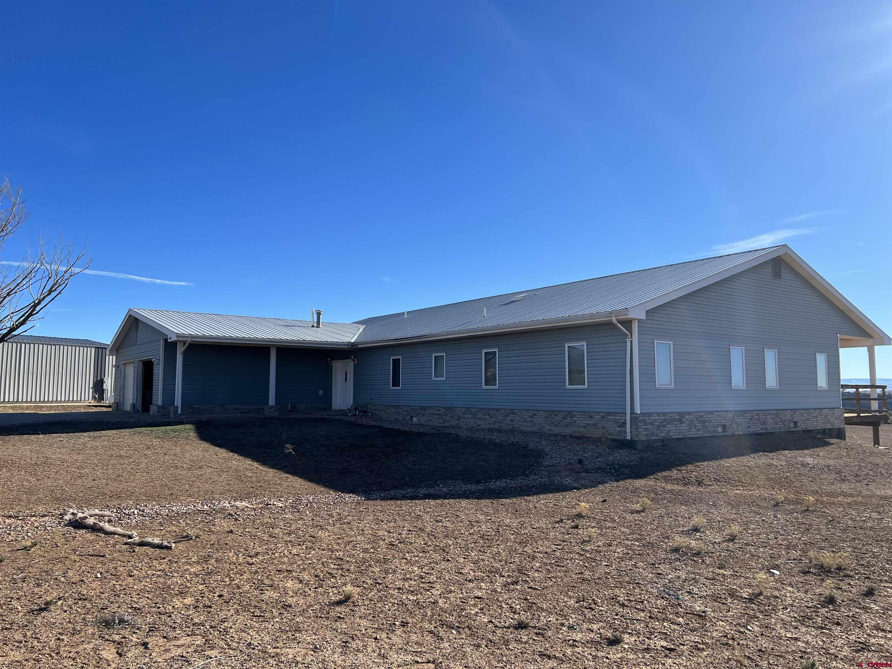 26096 Paintbrush Road Cedaredge, CO 81413 - Photo 1 of 29 a front view of a house with a yard