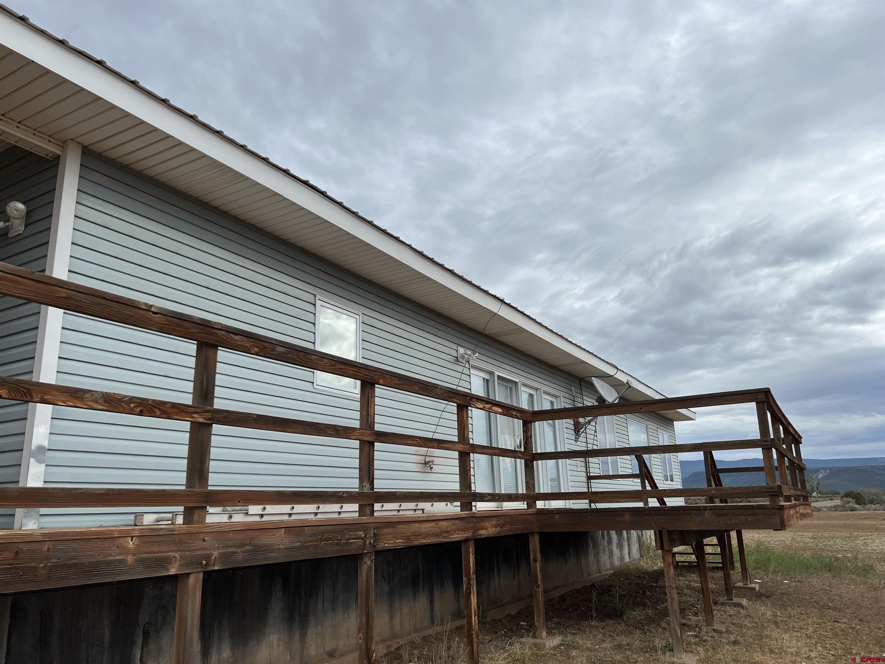26096 Paintbrush Road Cedaredge, CO 81413 - Photo 28 of 29 a roof deck with a table and a barbeque