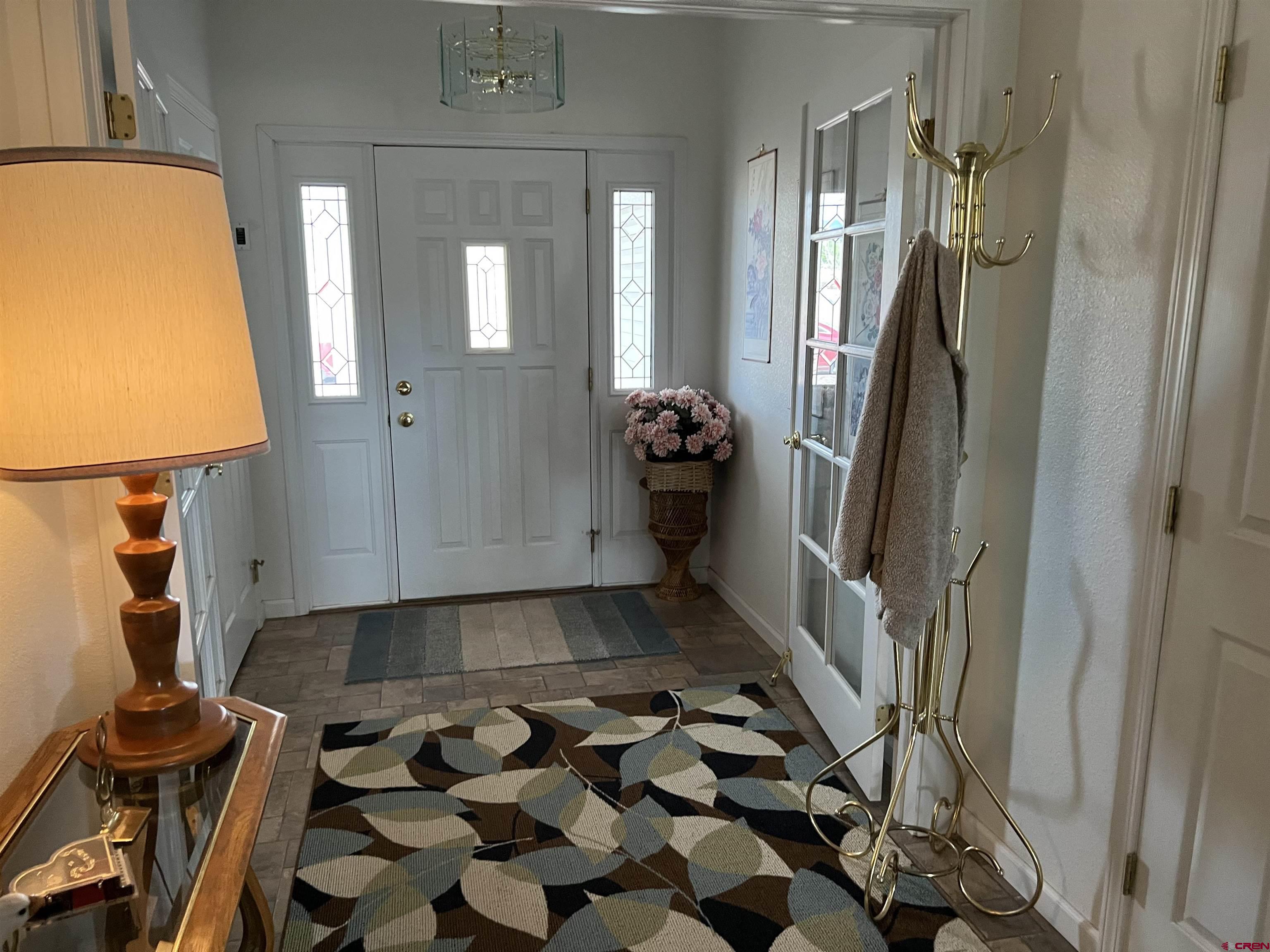 26096 Paintbrush Road Cedaredge, CO 81413 - Photo 4 of 29 a view of a entryway door with a couch