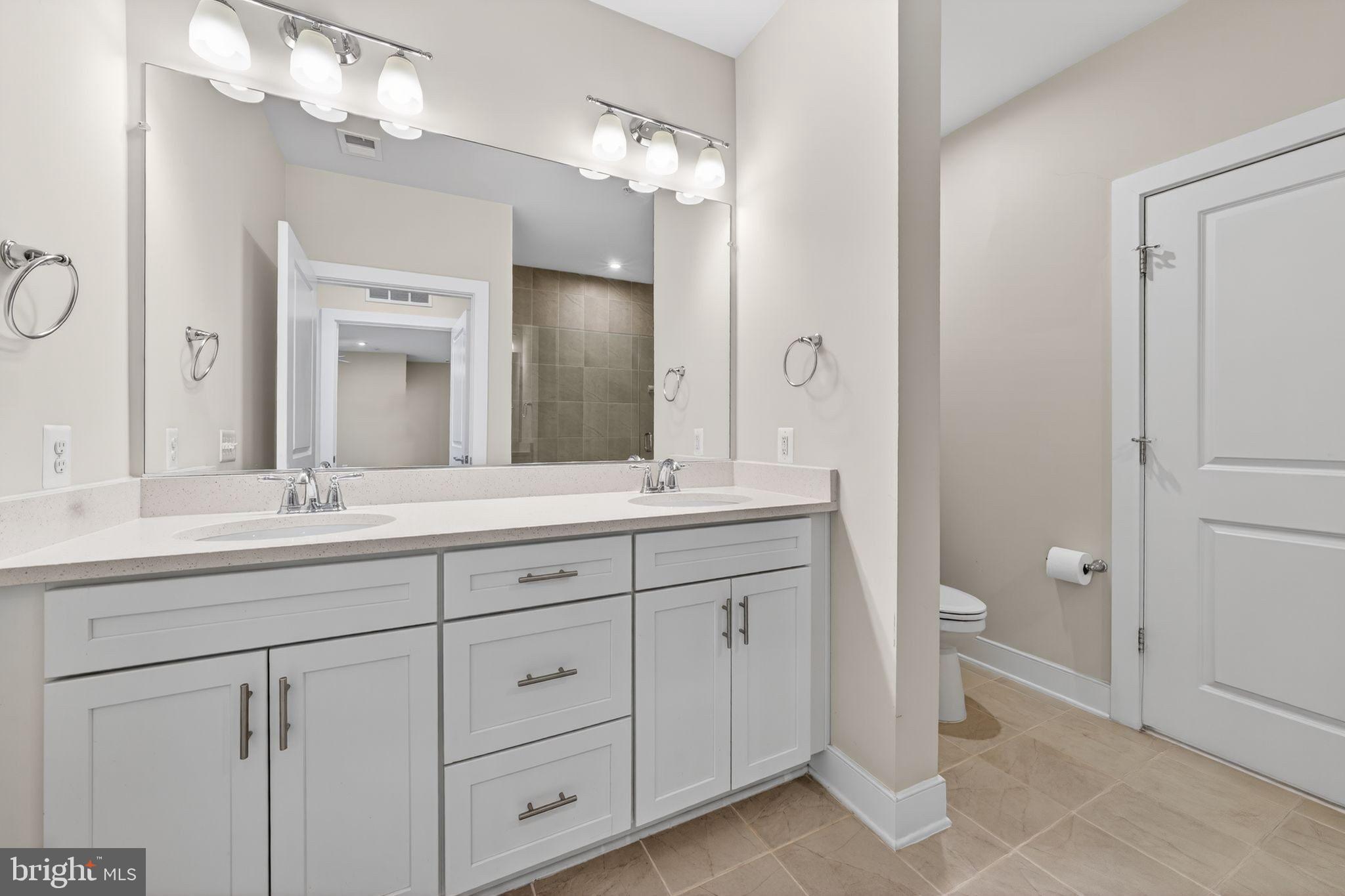 2319 Field Point Road, Unit 102 Herndon, VA 20171 - Photo 13 of 20 a bathroom with a double vanity sink and a mirror