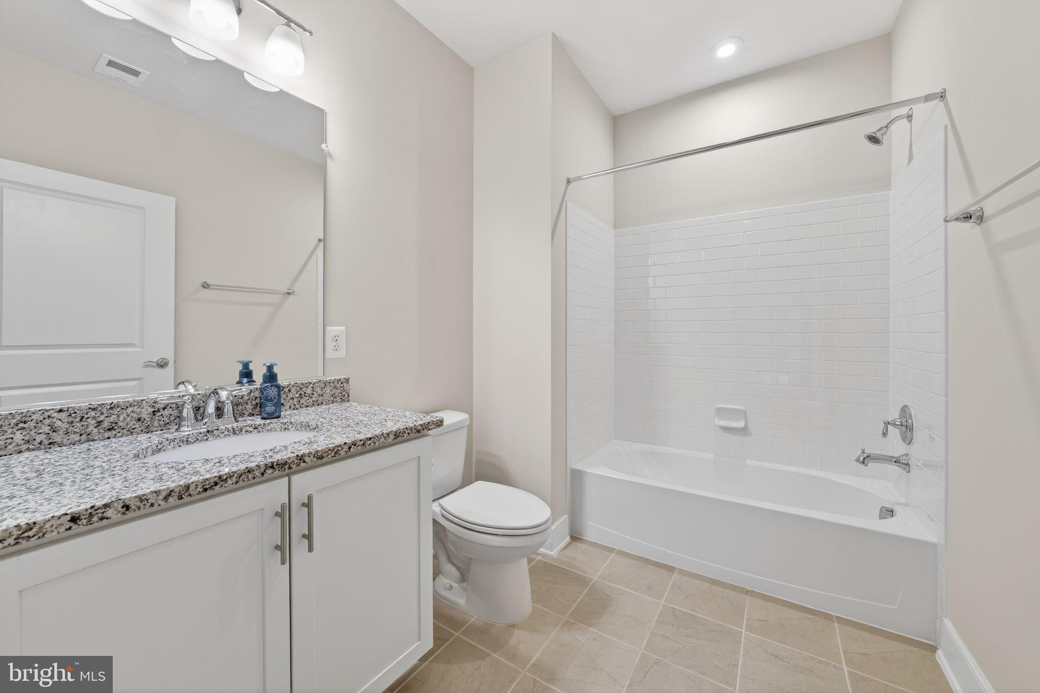 2319 Field Point Road, Unit 102 Herndon, VA 20171 - Photo 17 of 20 a bathroom with a granite countertop sink a toilet and shower